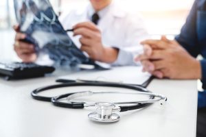 Neurologist reviewing test results with a patient during a restless legs evaluation